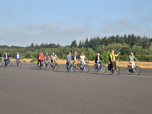 fietsers met gids op landingsbaan